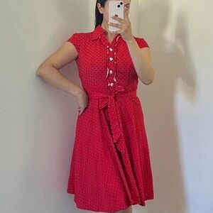 Retro style red polka dot dress with cap sleeves and heart-shaped white buttons